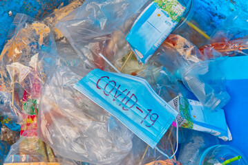 Mask in the trash can. The right way to throwing used face mask in the bin. Covovirus or Covid-19 concept.