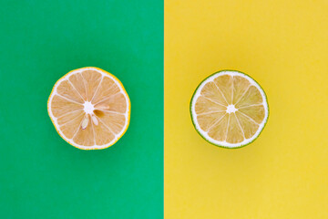 Lemon vs Lime.  Circle sliced yellow lemon and green  lime close up.