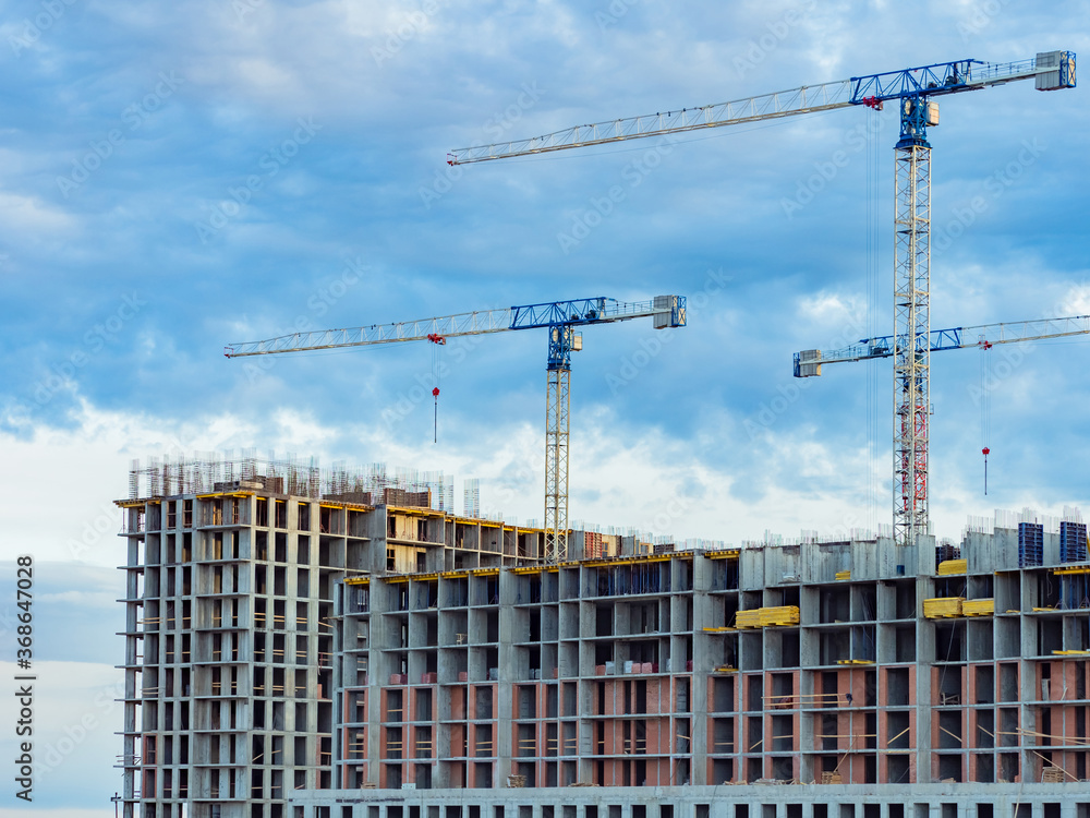 Poster multi-story residential building is being constructed using a crane. view of a large construction si