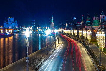 Fototapeta na wymiar Moscow. Russia. Kremlin embankment. Kremlin towers. Christmas decorations in the capital. New Year's Moscow with a quadcopter. Highway at night. Russian roads. Moscow on a winter night.