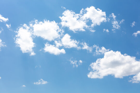 Puffy white clouds in a blue sky