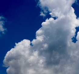 The white puffy clouds in the bright blue sky.