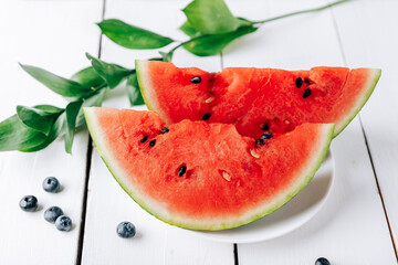 Summer still life of fresh fruit and berries on a white wooden surface