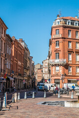 The different moments in the city center of Toulouse in the summer day. French