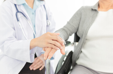 close up hand, female doctor use hand touch on hand of old patient, elderly healthcare clinic in hospital