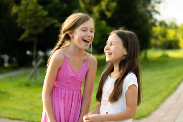 two young ladies laugh in the Park