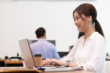 Business asian woman happy working job on laptop in office.
