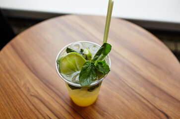 Mojito cocktail or soda drink with lime and mint on table in bar.Blurred image,selective focus