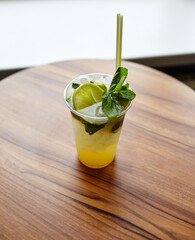 Mojito cocktail or soda drink with lime and mint on table in bar.Blurred image,selective focus