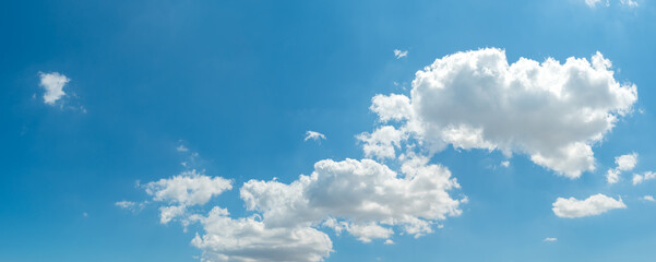Naklejka na ściany i meble Beautiful clouds on blue sky background, wide panorama of high resolution