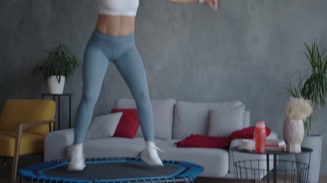 Young athletic woman exercising at home, active fat burning workout