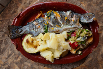 The traditional dish of Eastern Serbia - grilled mountain trout with garlic, lemon, parsley and olive oil