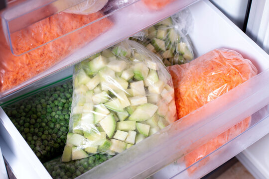 Bags with frozen vegetables in refrigerator. Frozen Zucchini