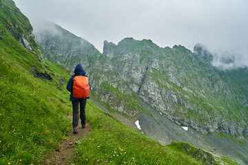 Fototapeta na wymiar Lady hiker on a trail in the mountains