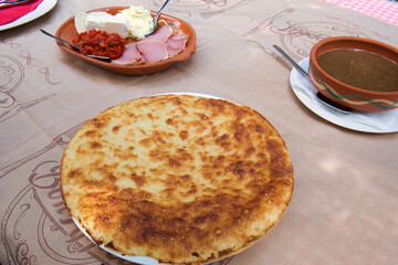 Traditional Kosovo pie - layered pita rednica stuffed with cheese and baked in a special pot, sac