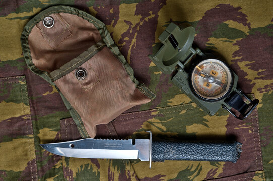 compass and knife on camo textile