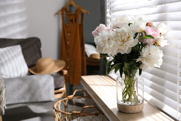 Bouquet of beautiful peony flowers on window sill indoors. Space for text