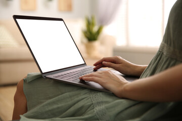 Woman using laptop at home, closeup. Space for design