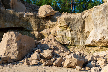 Big stones in limestone quarry. Hillside wall behind. Mine in Jozefow, Poland, Europe.