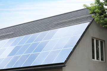 Fototapeta premium House with installed solar panels on roof. Alternative energy source