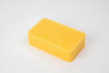 Sponge on white background. Yellow household cleaning sponge.