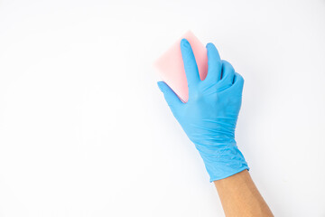 Sponge and spray for cleaning in female hand. Hand in a latex glove isolated on white. A hand in a glove holds a sponge and spray  cleaning.