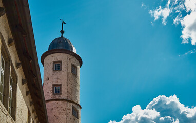 an old beautiful tower standing alone with blue sky in the background