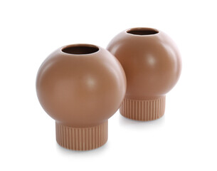 Stylish empty brown ceramic vases isolated on white