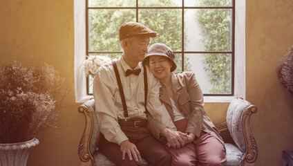 Vintage retro classic dress Asian elder senior couple taking photo at luxury home together