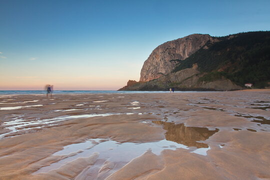 Ibarrangelu, Bizkaia/Basque Country; Sept. 26, 2015. People strolling at sunset on Laga beach at low tide.