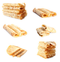 Set of tasty thin pancakes on white background