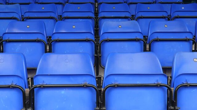4K: Empty plastic seats in the stadium. The chairs are blue with no spectators there. Tracking Shot. Stock Video Clip Footage