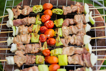 A variety of delicious grilled meats mixed with vegetables rather than charcoal on the barbecue are ready to be given.