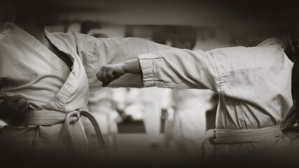 Kids training on karate-do.  Black and white. Photo without faces.