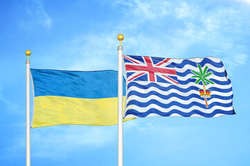 Ukraine and British Indian Territory two flags on flagpoles and blue sky