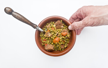 Peas, Pisum sativum, with stewed meat. With white background Asturias, Spain