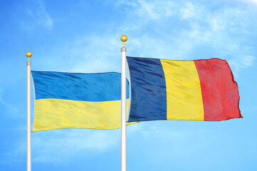 Ukraine and Chad two flags on flagpoles and blue sky