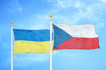 Ukraine and Czech Republic two flags on flagpoles and blue sky