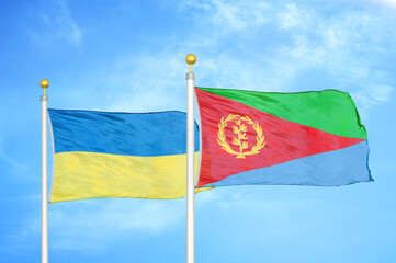 Ukraine and Eritrea two flags on flagpoles and blue sky