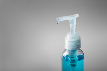 Drop of alcohol gel from bottle with isolated white background with copy space. Hand sanitizer gel for clean and against the corona virus, covid-19, bacteria. Hand sanitizer in pump bottle.