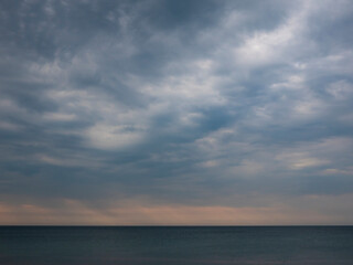 Naklejka na ściany i meble Evening sky over the sea. Horizon over the sea surface