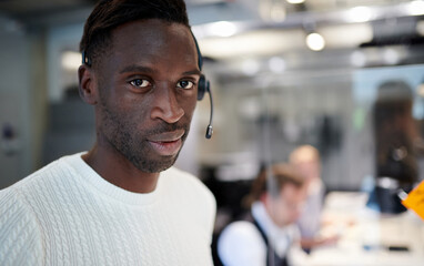 Obraz premium Closeup portrait of confident male professional with headphones working at creative office