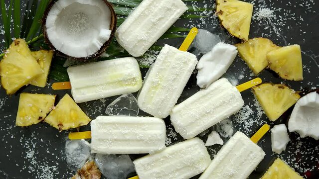 Summer popsicles on stick. Pinacolada flavour. Made with pineapple, cocount milk, rum. Vegan snack