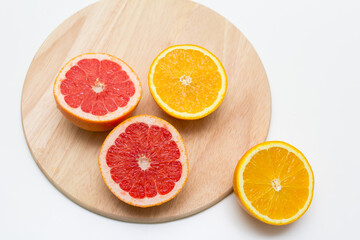 cut into sticks grapefruit and orange on a wooden Board