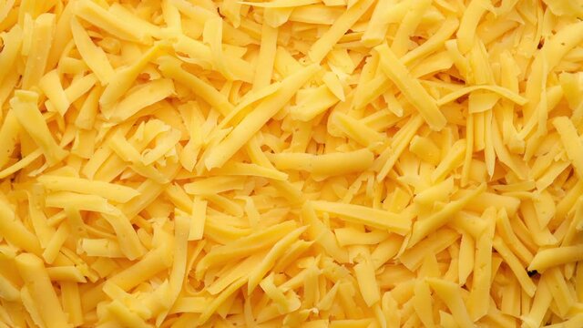 cheddar cheese grated top view rotating