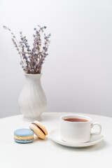 macarons on background Cup and vase with lavender.