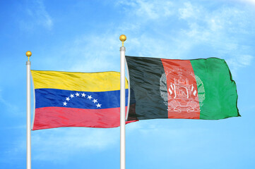 Venezuela and Afghanistan two flags on flagpoles and blue sky