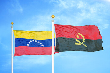 Venezuela and Angola two flags on flagpoles and blue sky