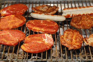 grilled steak and sausages on grill