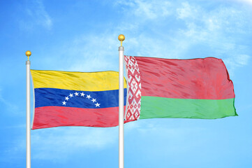 Venezuela and Belarus two flags on flagpoles and blue sky
